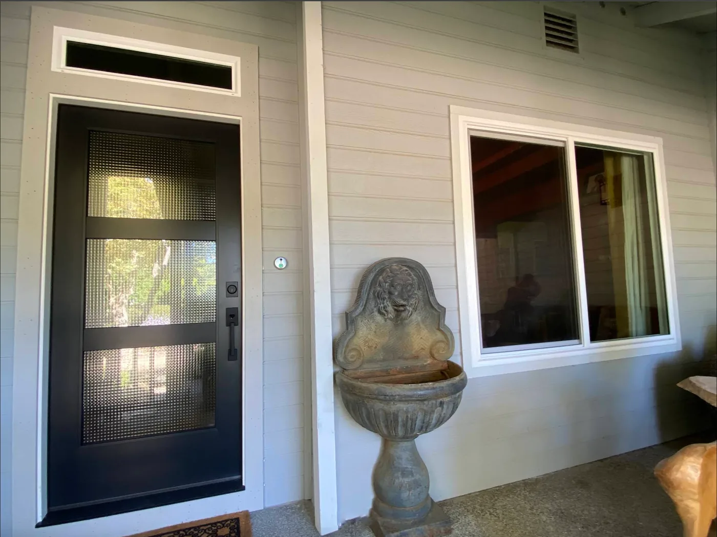 Black entry door and adjacent window